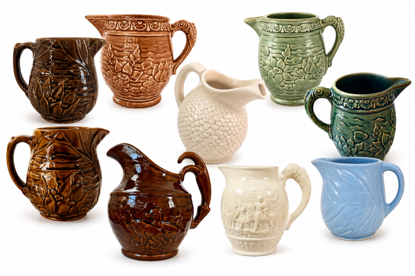 A grouping of McCoy pottery pitchers in various colors and patterns