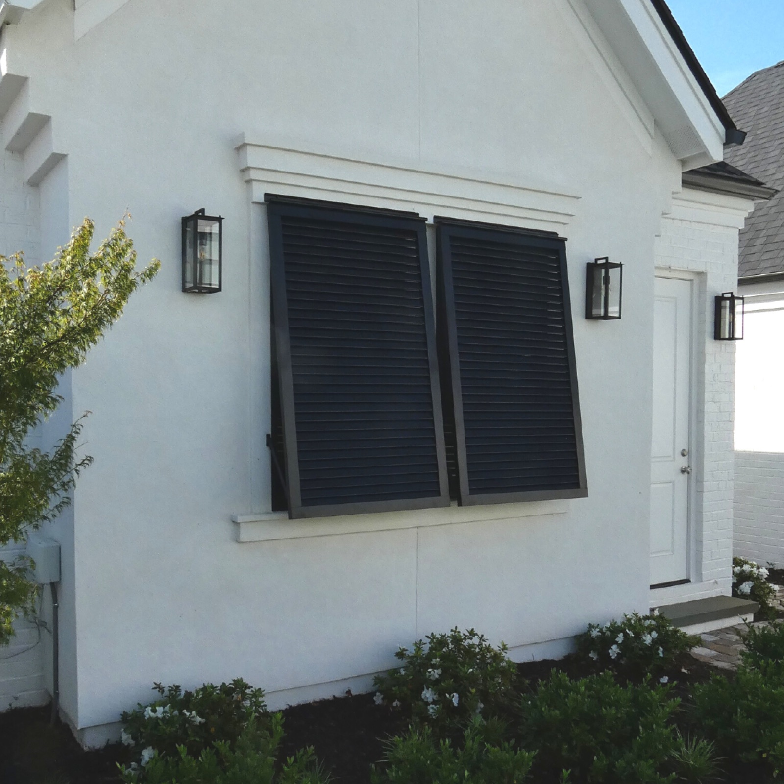 Faux exterior window with closed black shutters for balance and symmetry